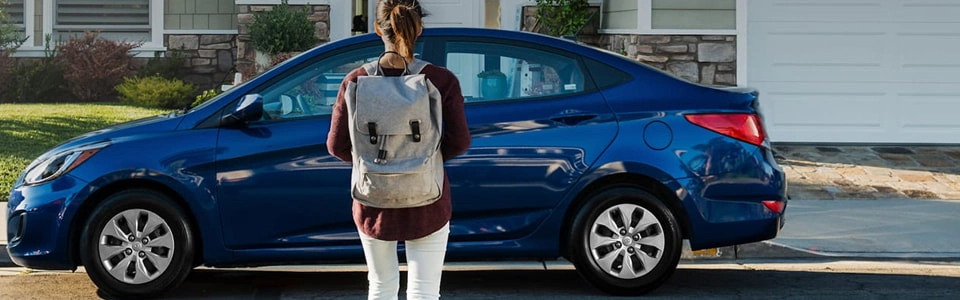 College grad facing a new, blue car